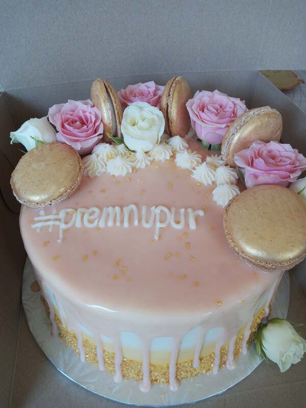 Gold to white gradient cake with pink drip icing, gold macarons and pink and white roses
