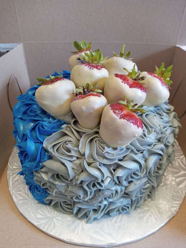 Blue rosette cake with white chocolate dipped strawberries
