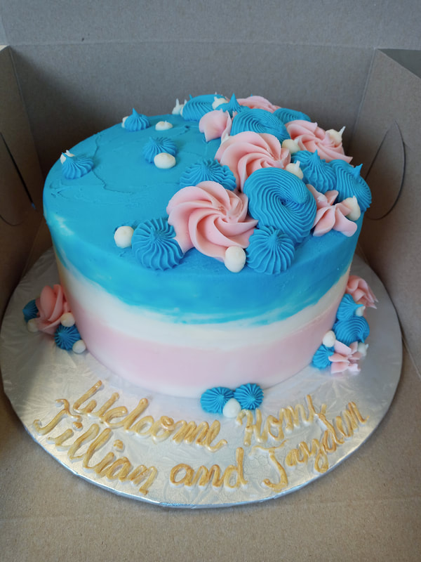 Pink white and blue cake with same coloured decoration
