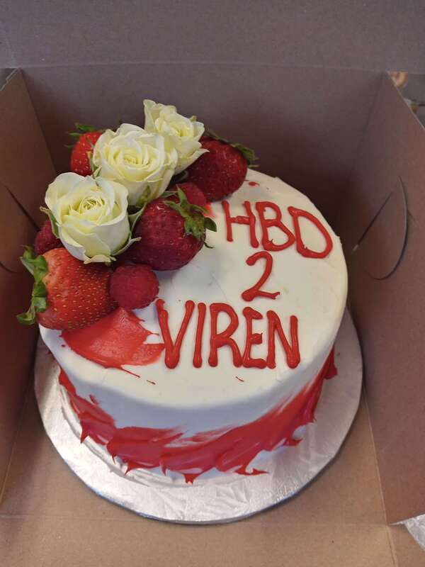 White cake with strawberries and white roses