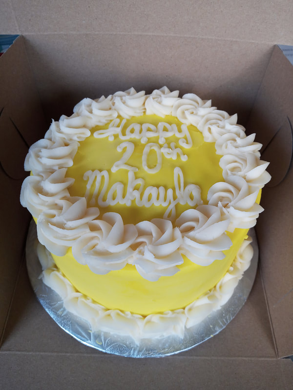 Yellow 20th birthday cake with white rosette border