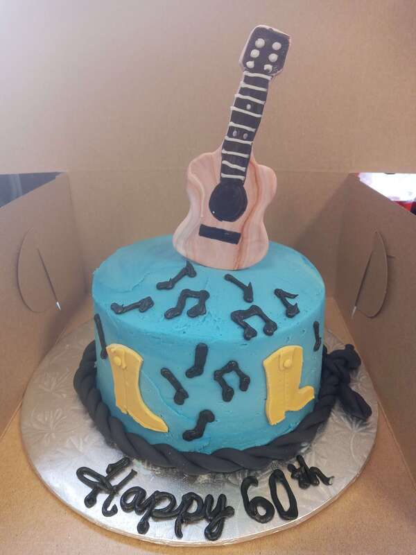 Blue cake with a guitar, music notes and boots