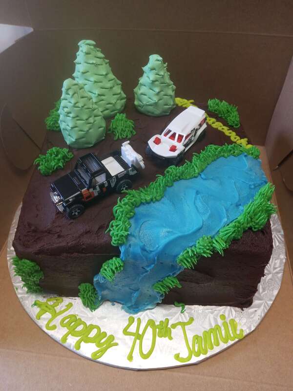 Forest cake with two cars and a river