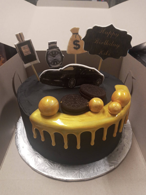 Black birthday cake with some gold grip icing and pictures of expensive things