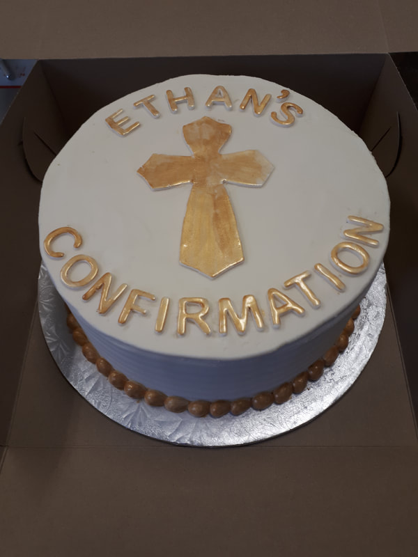 White communion cake with gold cross, writing and border