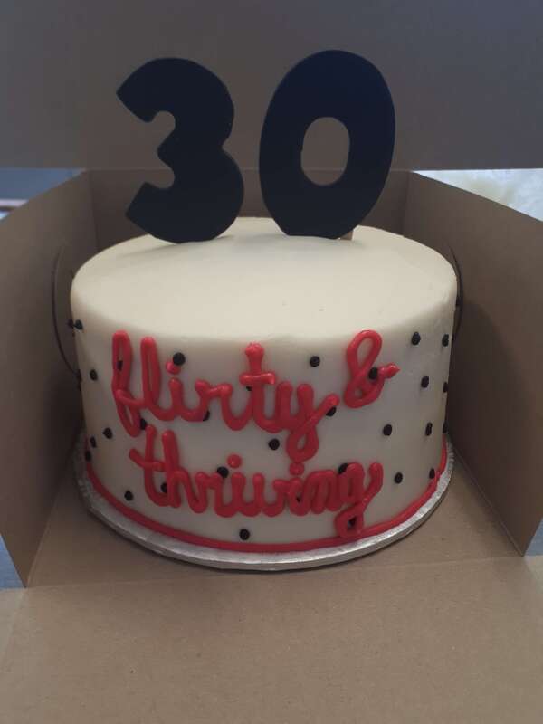 White cake with small black polka dots