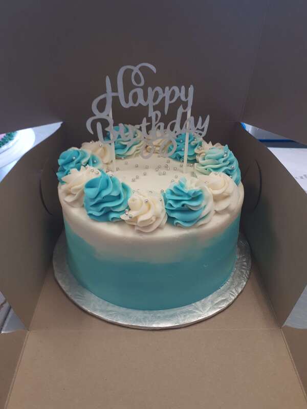 Blue to white gradient cake with blue and white decorations