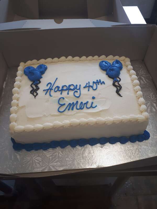 White cake with blue balloons