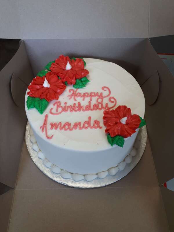 White birthday cake with three red Hibiscus