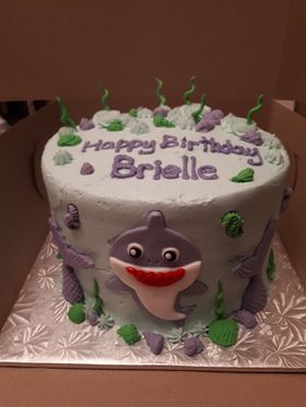 Under the sea cake with a purple shark and purple mermaid tails